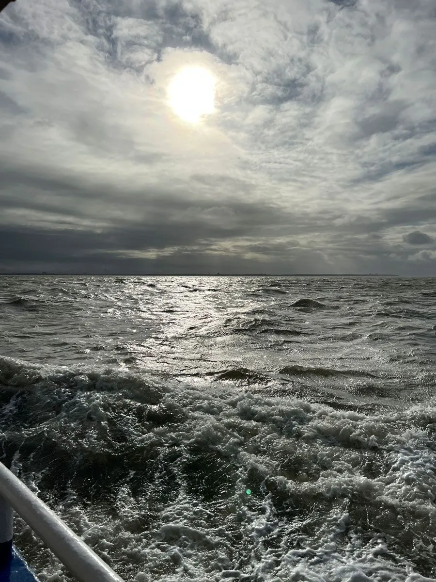Dark seawater with a little sun in the sky